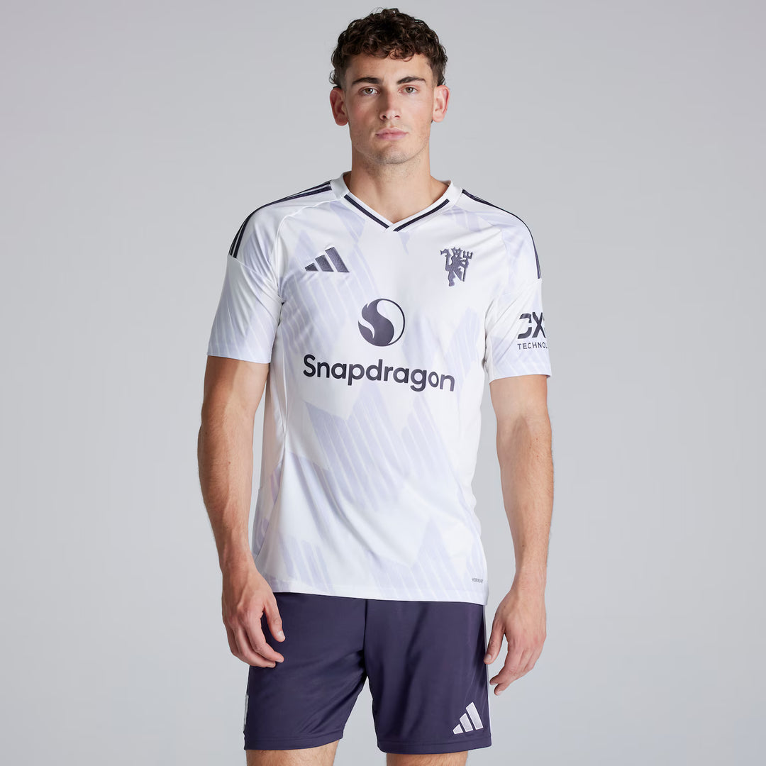 Person wearing a white sports jersey with branding on a gray background