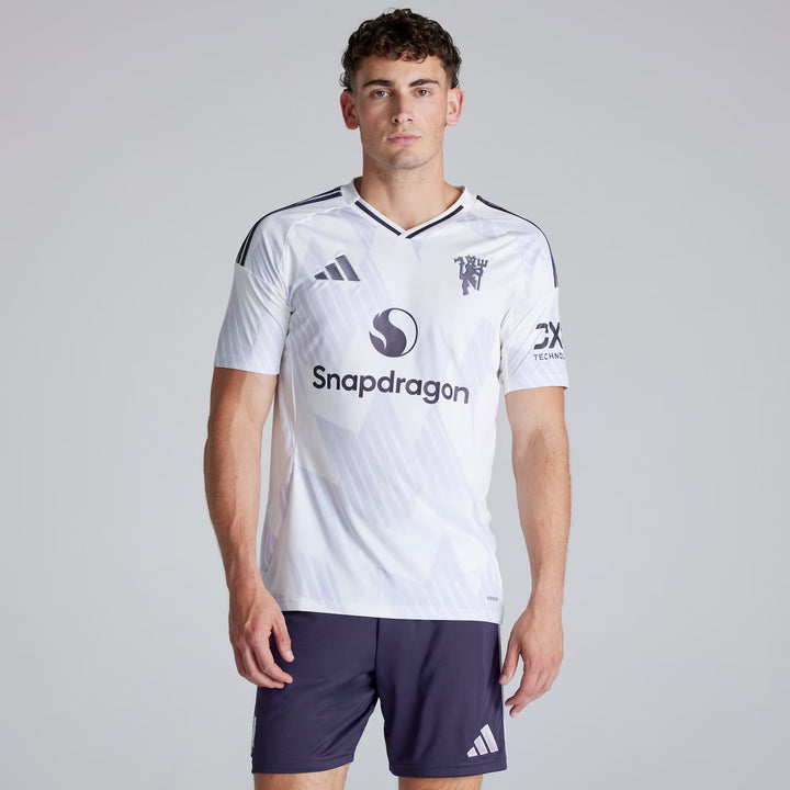 Person wearing a white sports jersey with branding on a gray background